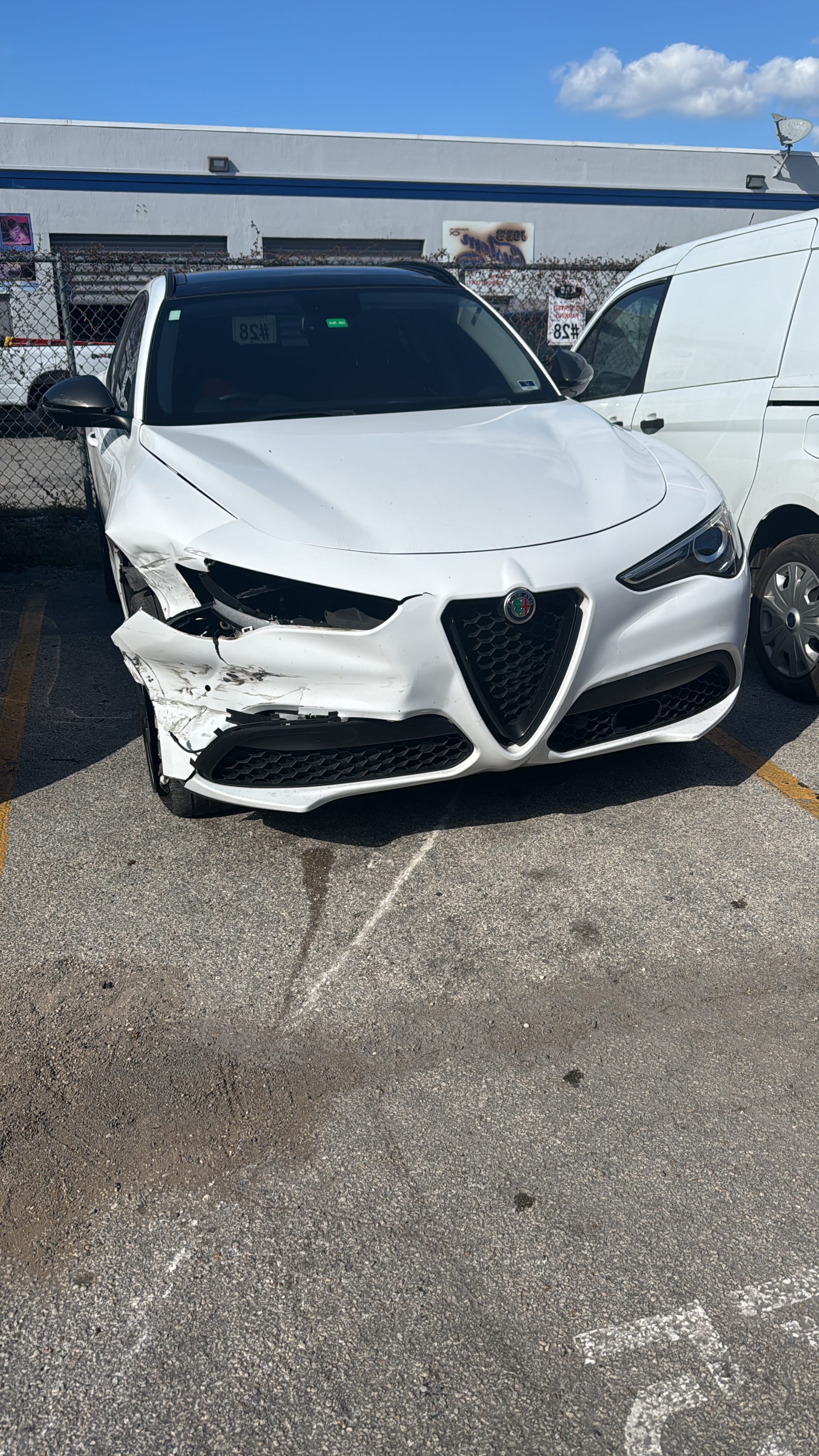 Alfa Romeo Stelvio with a crushed passenger-side front end after a collision