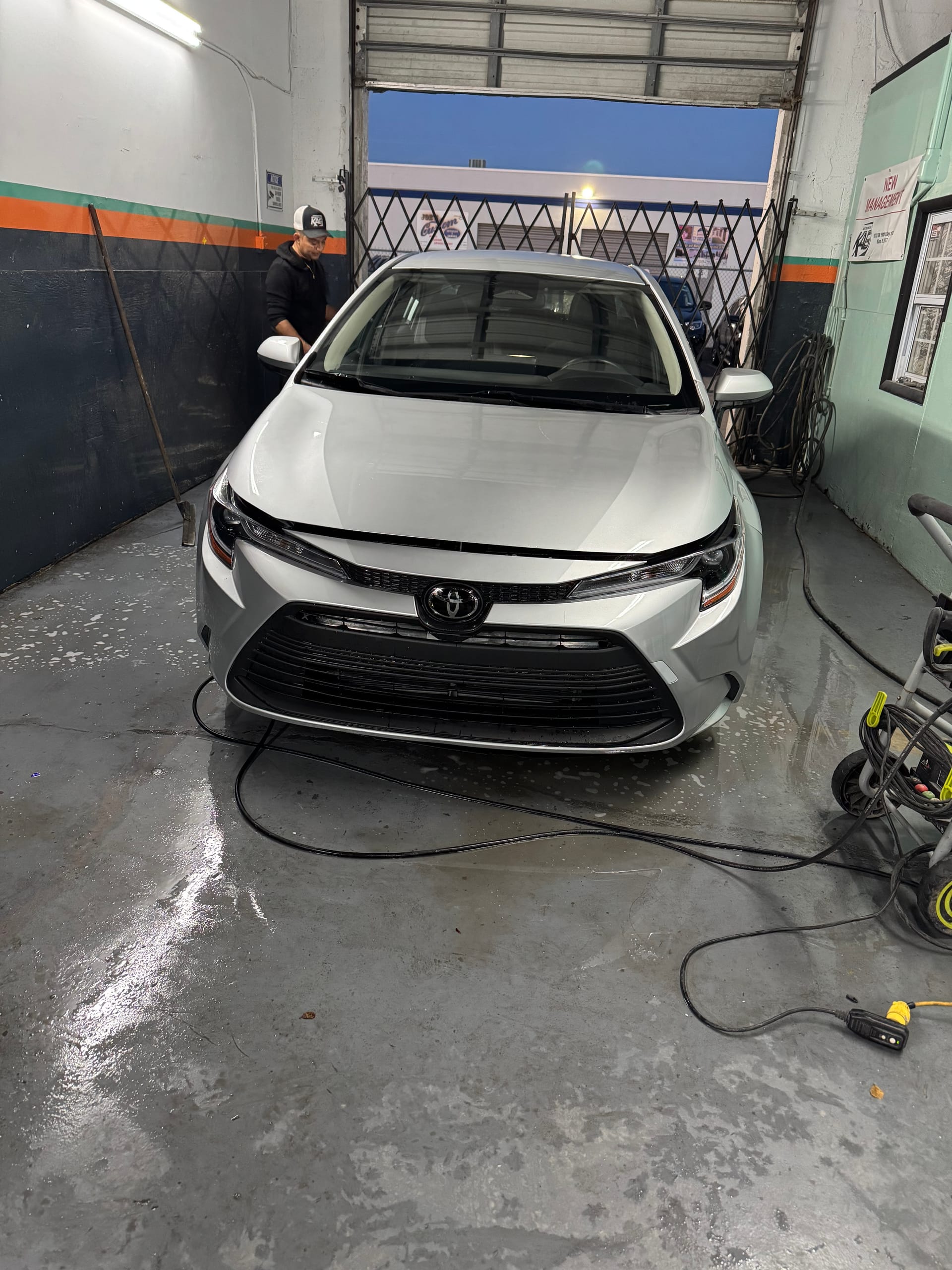 The same Corolla with the front end rebuilt, back on the shop floor in Cutler Bay