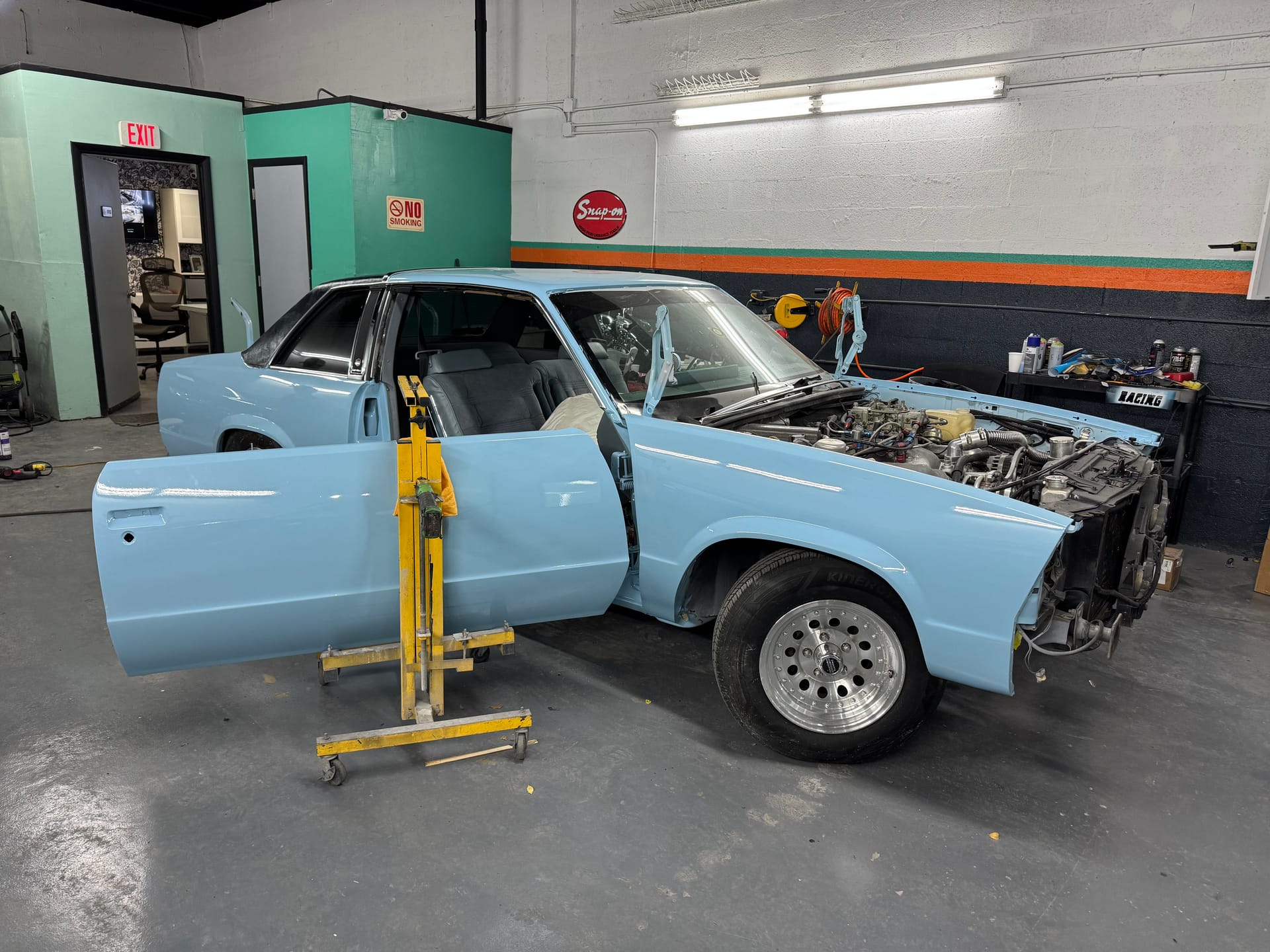 The same Malibu in gloss light blue, back on the shop floor for reassembly