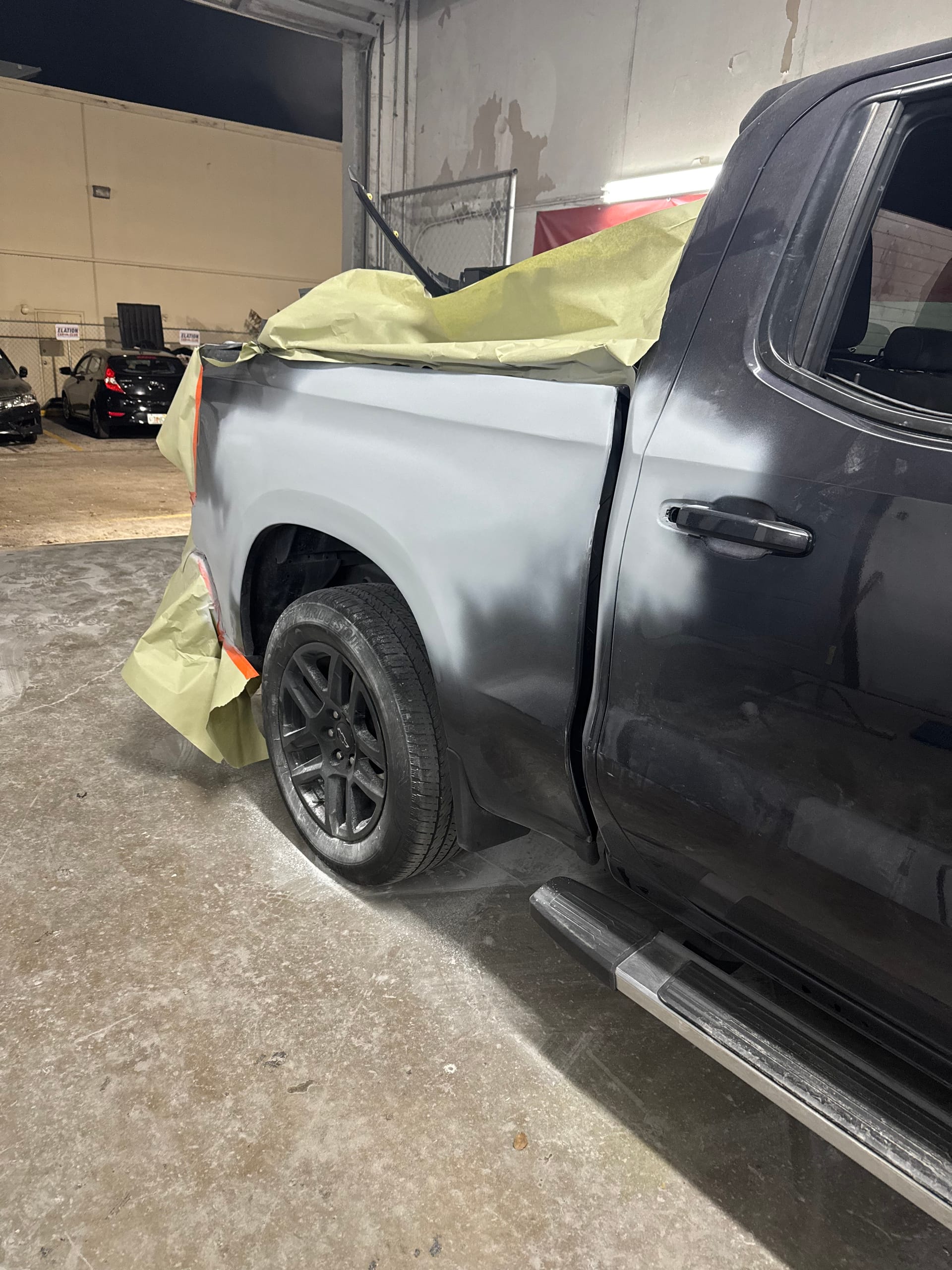 Black Chevy Silverado bedside sanded to primer and masked