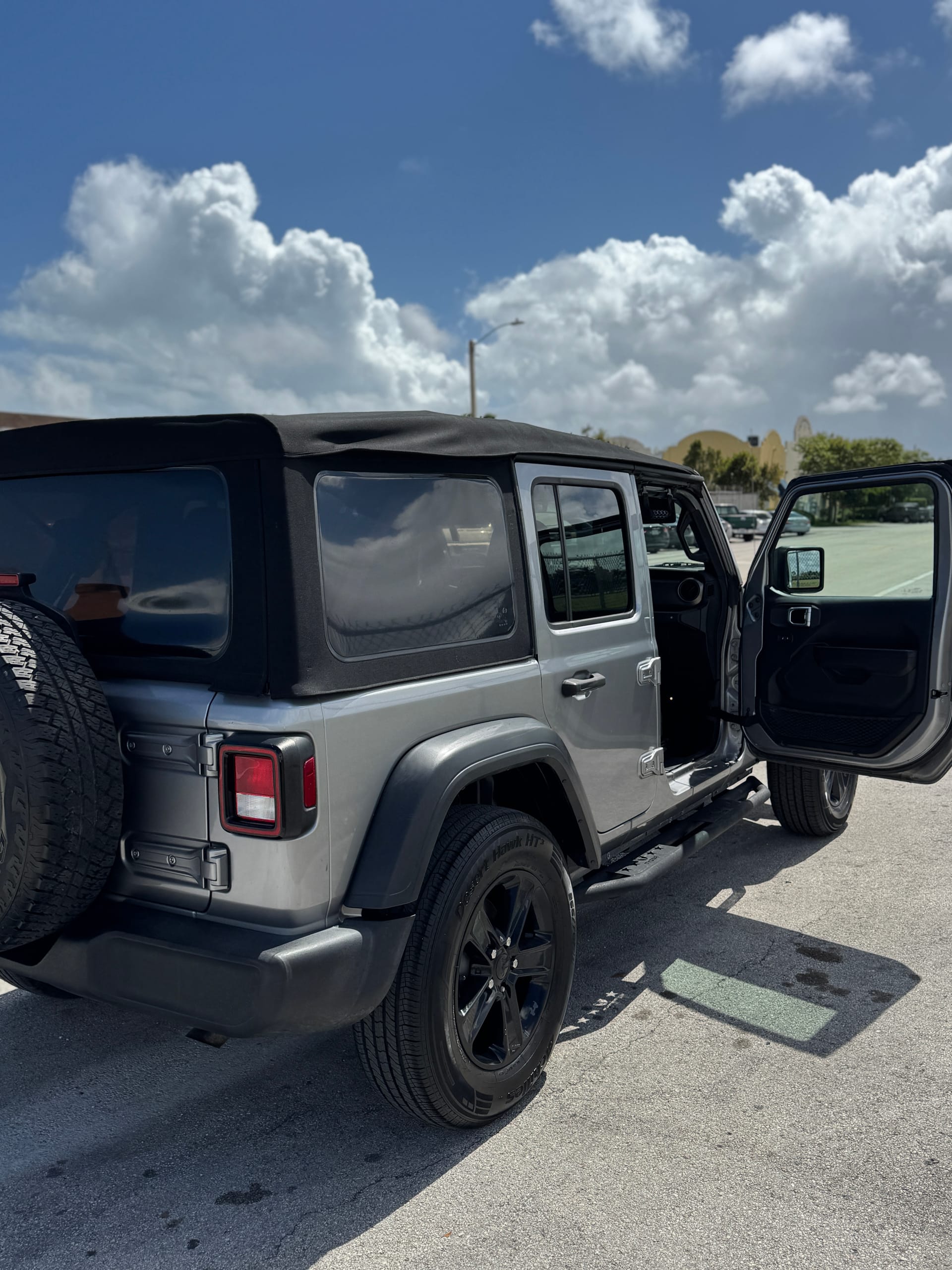 Silver Jeep Wrangler Unlimited, finished, rear quarter with the spare tire