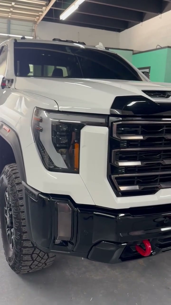 The same GMC Sierra AT4X HD with the front end rebuilt, walkaround inside the shop