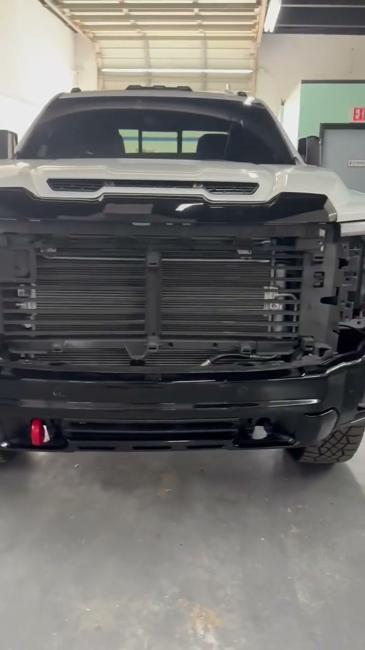 GMC Sierra AT4X HD with the grille and front bumper removed before collision repair